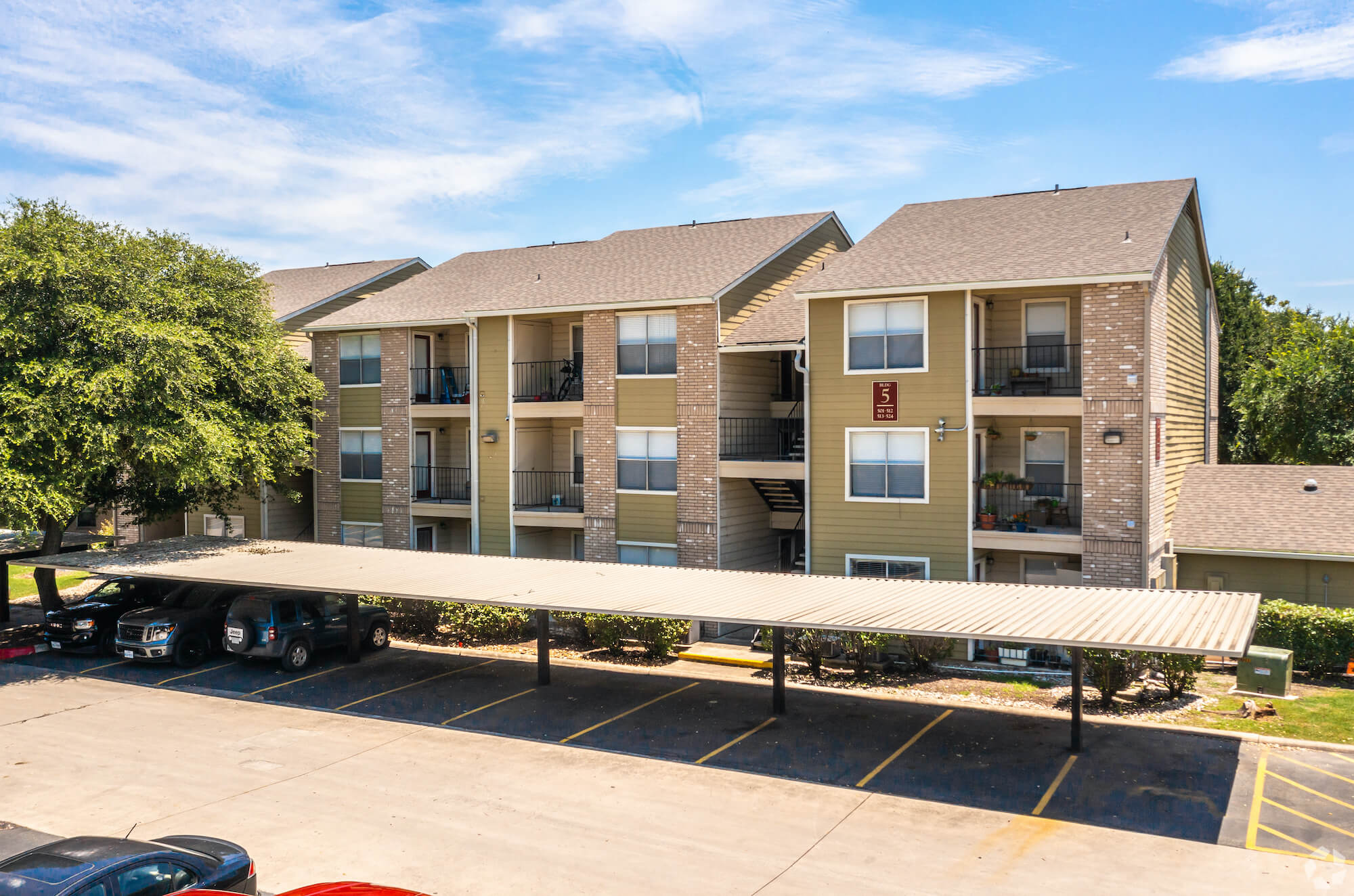 The Avalon Apartments and covered parking lot