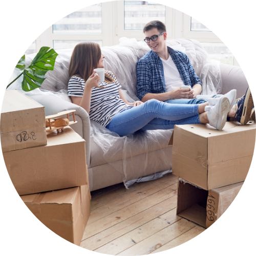 A couple on the couch, taking a break from moving