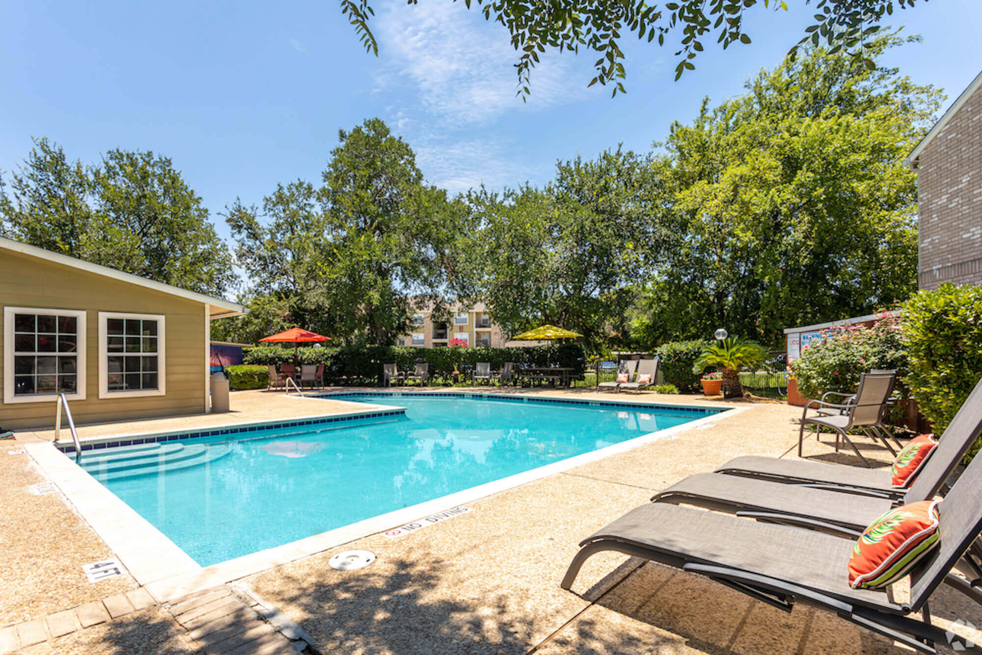 The Avalon Apartments outdoor pool area with chairs