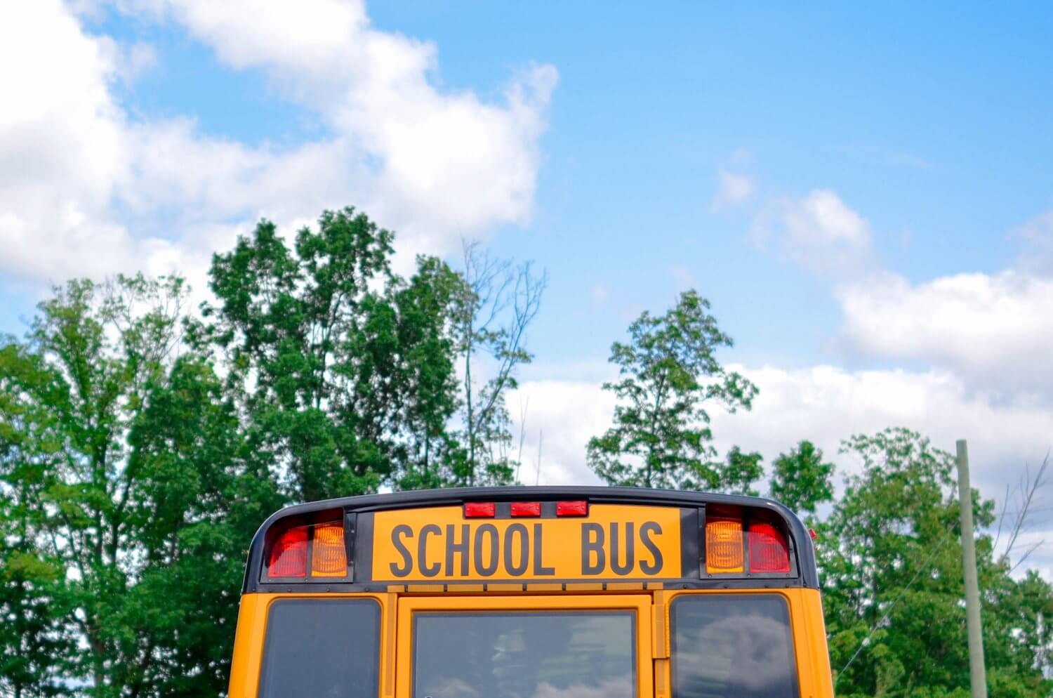 School bus under a bright blue sky